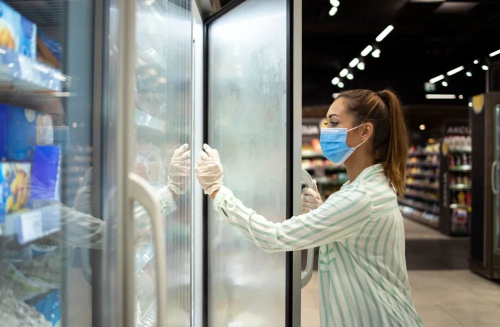 Chiller technician performing maintenance on a commercial freezer in Dubai, ensuring optimal functionality.