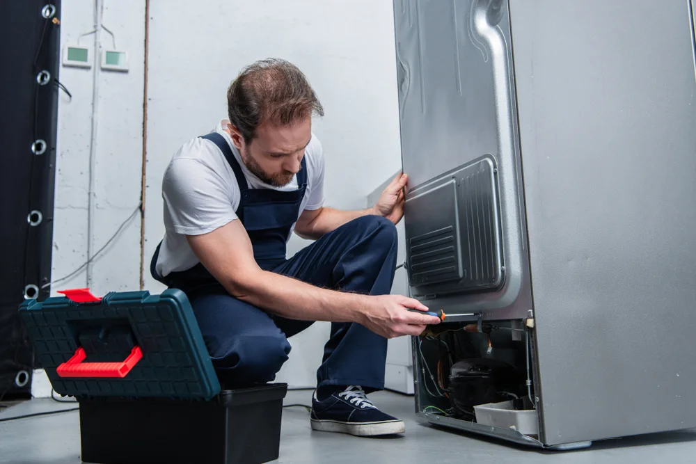 Prime Pro Technical technician fixing refrigerator compressor in Dubai.