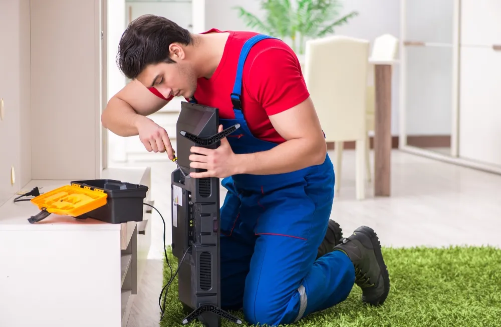 Technician repairing flat-screen television aligned with Philips TV customer care UAE services