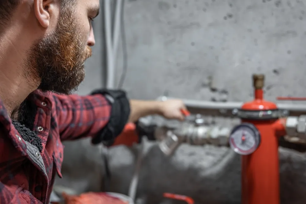 Technician inspecting industrial electric water pump for repair and maintenance in UAE