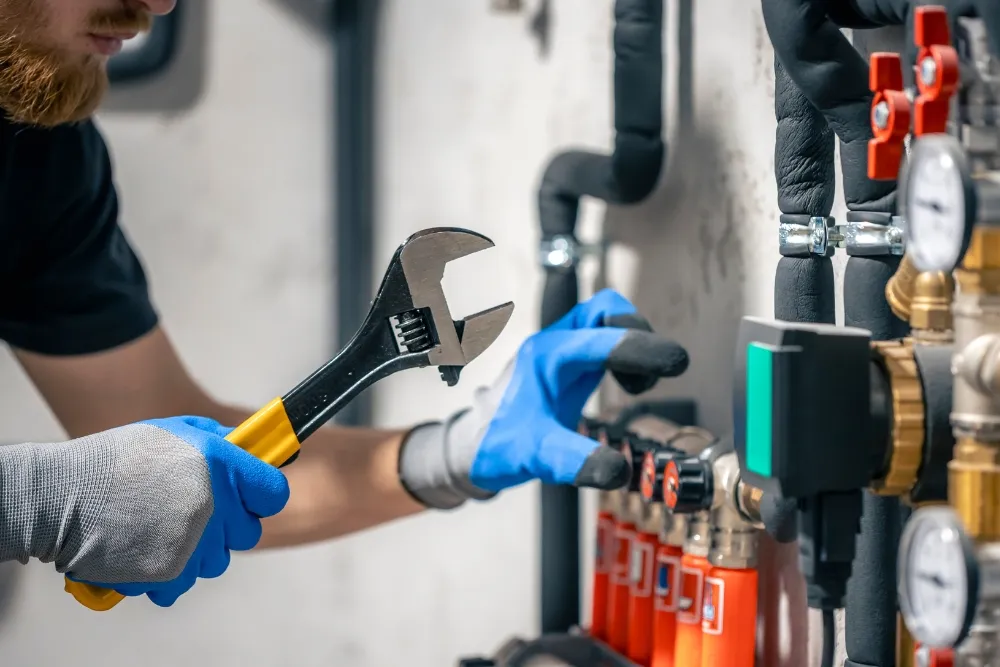 Technician observing electric water pump system during inspection in UAE