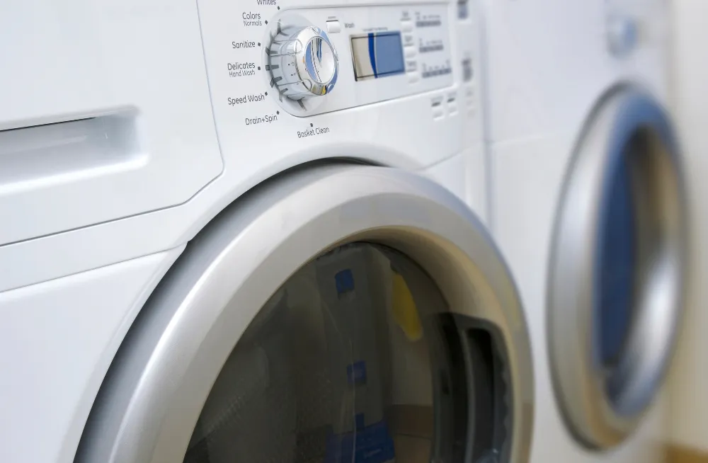 Technician assisting customer with clothes dryer repair booking