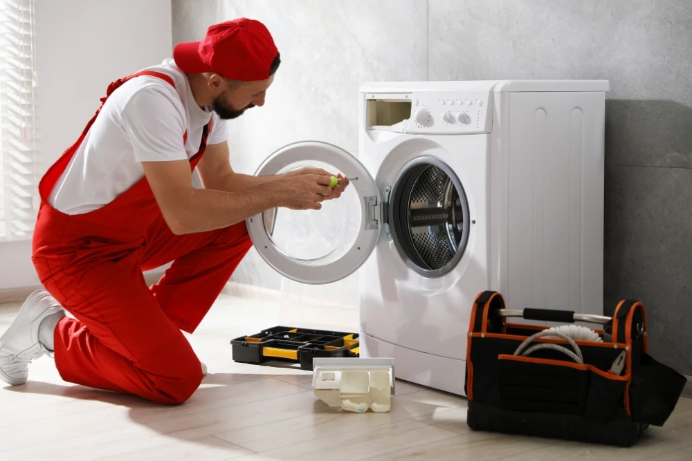 Technician repairing residential clothes dryer
